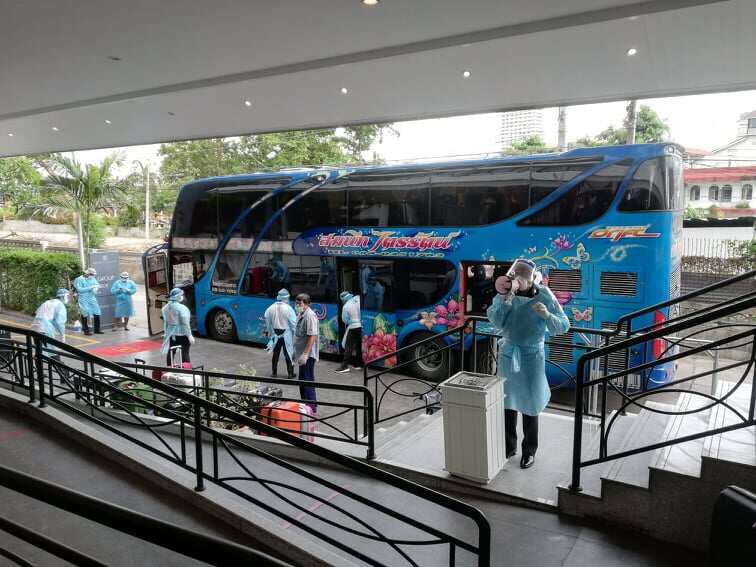 A double-deck bus where the returned travellers are being transferred to the state quarantine hotel.