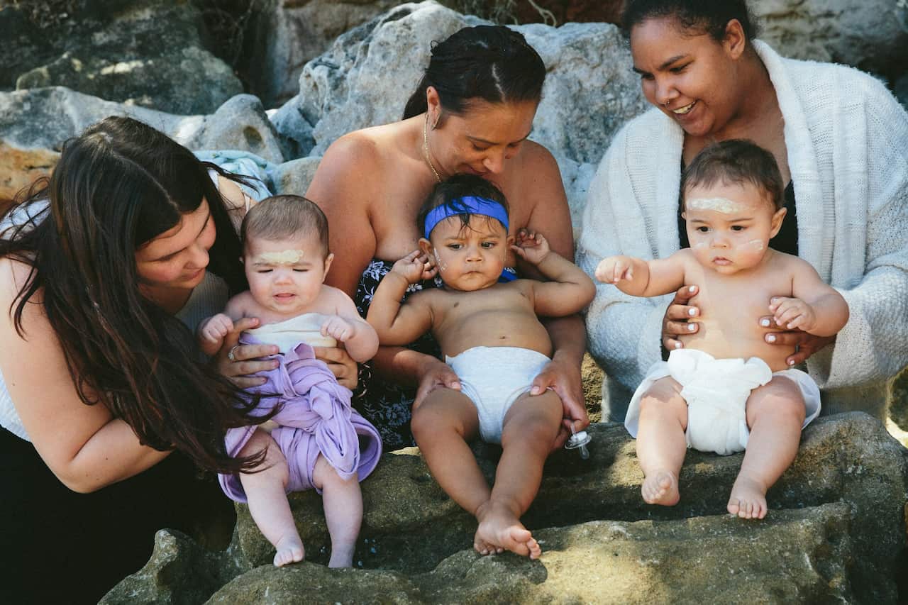 Smoking Ceremony, Welcoming Waminda Goodjaga’s on Yuin Country. L–R; Gemmah Floyd, Elizabeth Luland, Patricia De Vries and their babies.