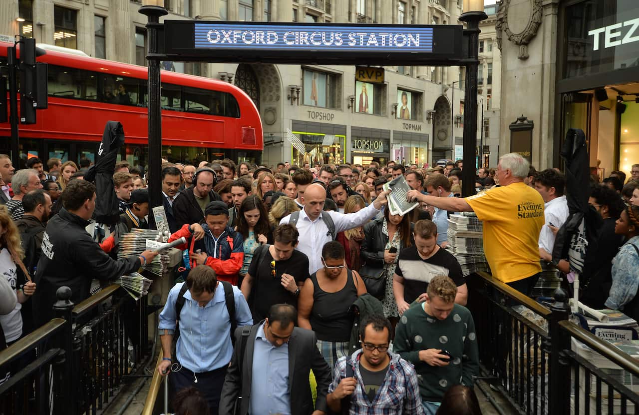 People queuing at an entrance to Oxford Circus station, London. 