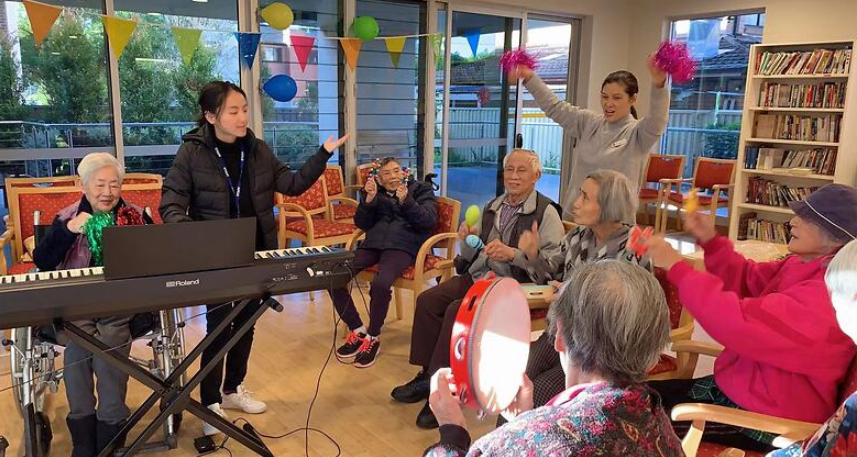 A group of Asian elderly people enjoying music.