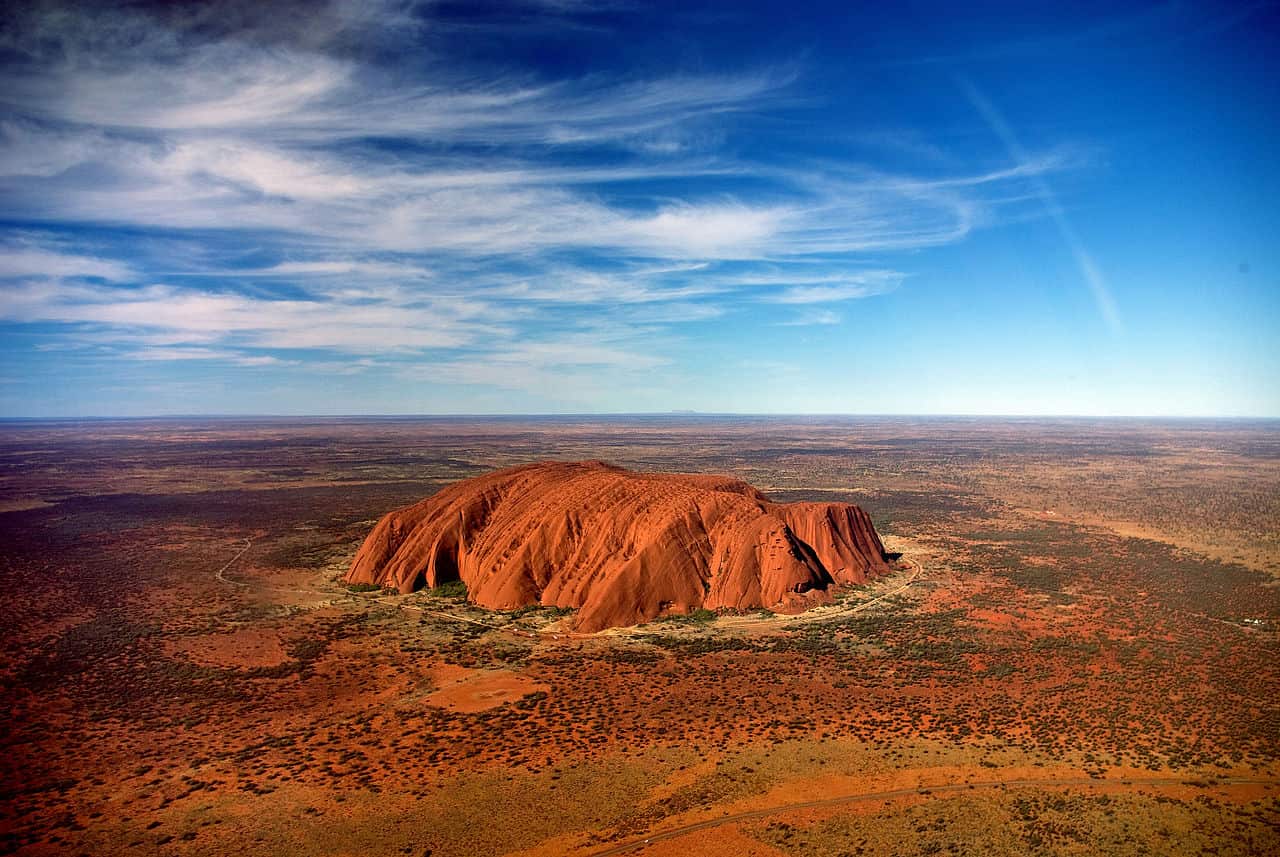 Uluru from a Helicopter, in the background the Mount Conner
