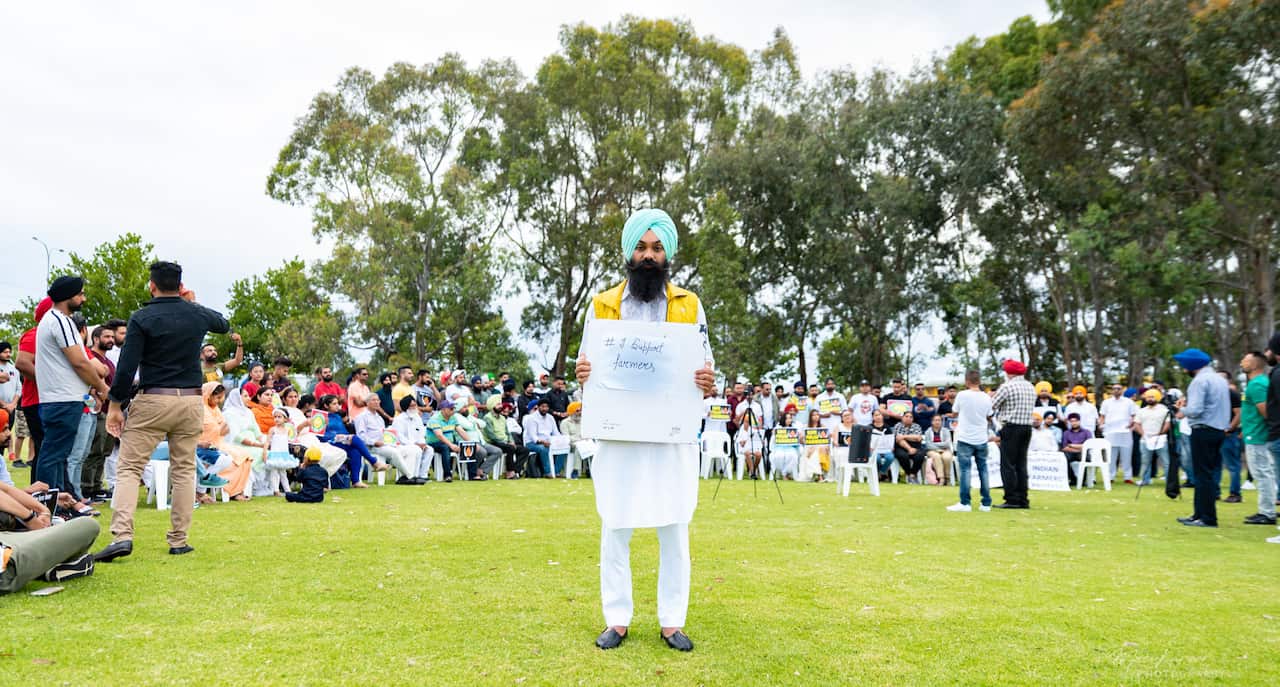 Dalwinder Singh along with a group of people holding banners at Perth to show their solidarity with the Indian farmers’ protests.