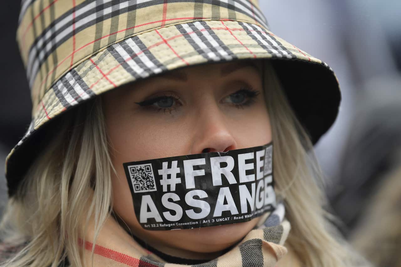 A supporters of Wikileaks founder Julian Assange protests in front of the Woolwich Crown Court in London.