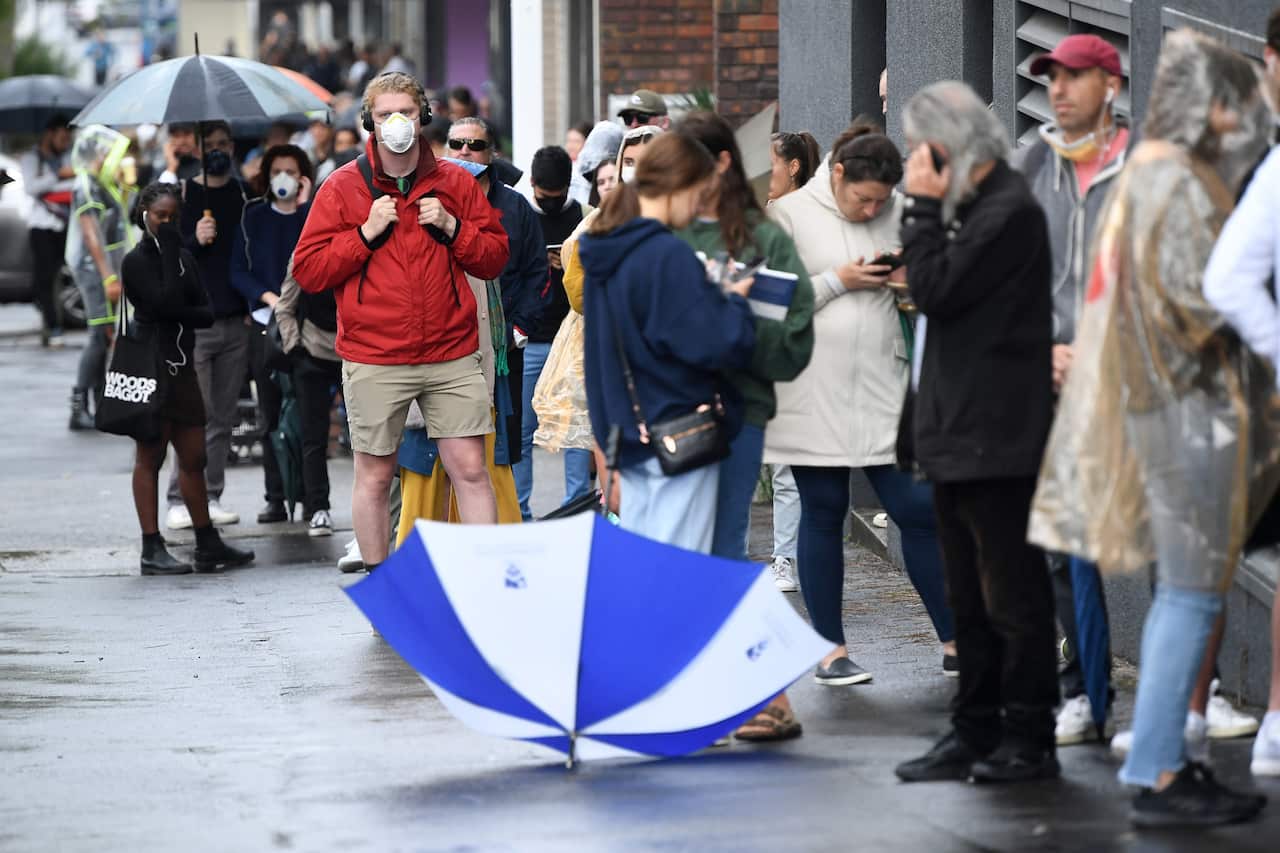 People are seen queuing outside a Centrelink office in Bondi Junction, Sydney.