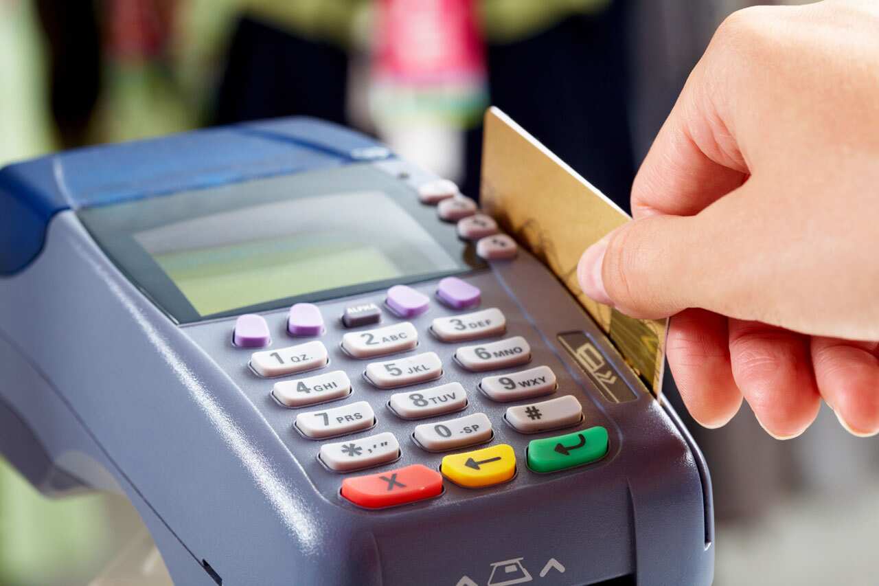A debit card being swiped through an EFTPOS machine in Canberra