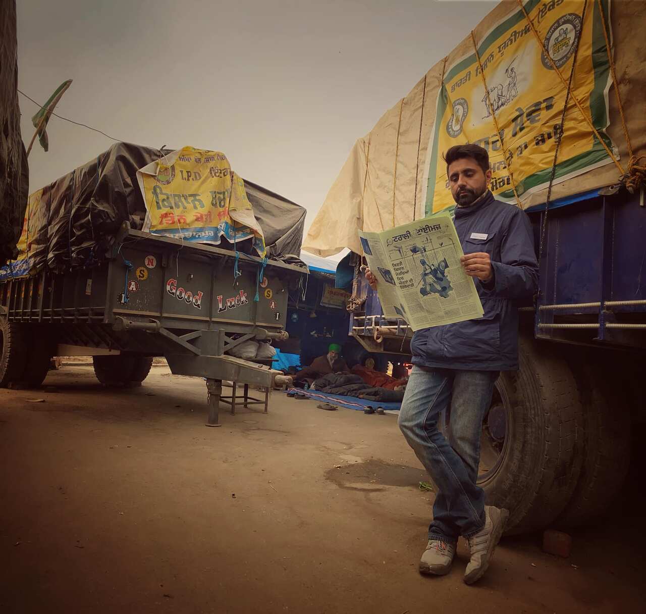 Bhavjit Singh reading the 'Trolley Times' at the Singhu border, Delhi. Protesting farmers have launched this bilingual newspaper to share information.