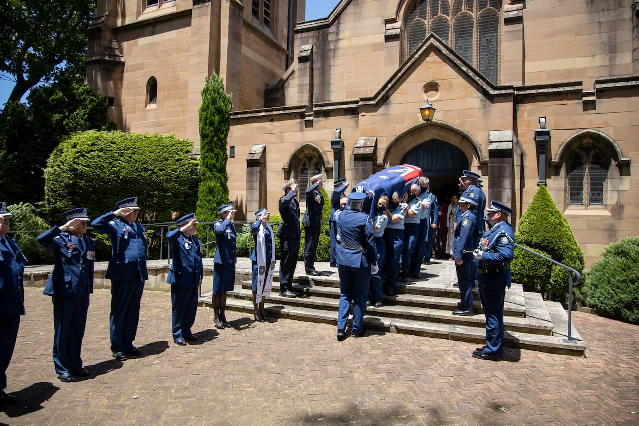 Coffin of Sen Con Kelly Foster being carried by colleague into church