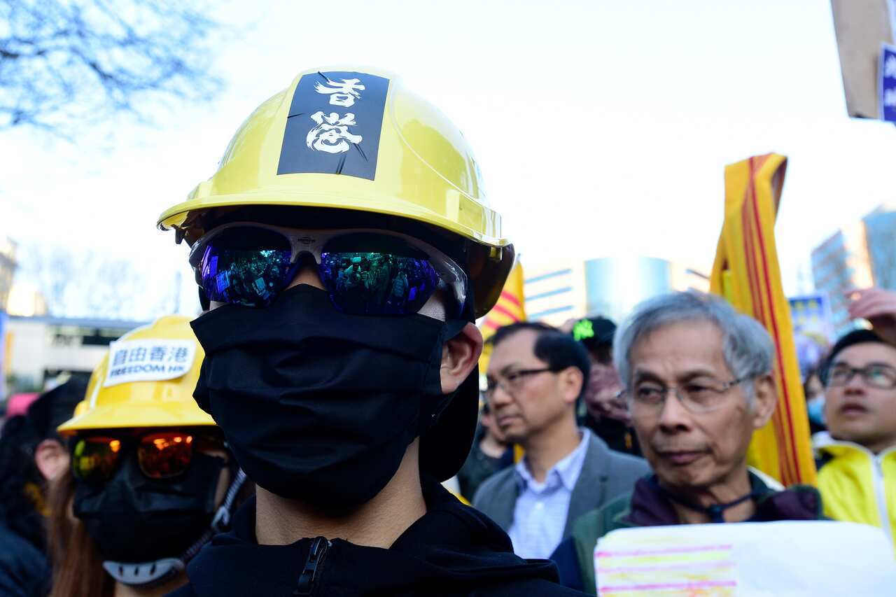 Pro-democracy Hong Kong supporters gather at a demonstration in Sydney, Sunday, August 18, 2019. (AAP Image/Bianca De Marchi) NO ARCHIVING