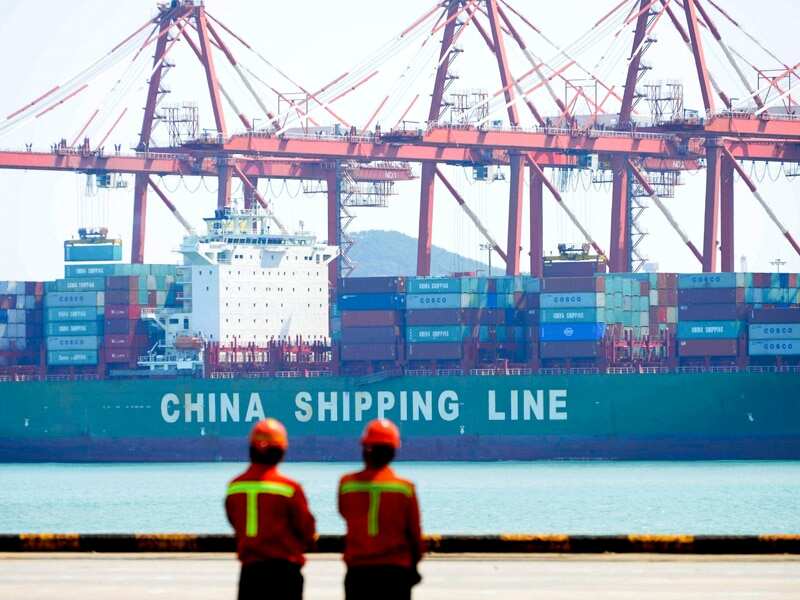 Containers are loaded into a cargo ship in Qingdao, China