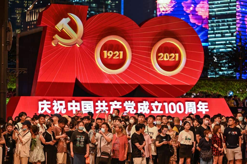 People stand outside a display commemorating the 100th anniversary in Shanghai. 