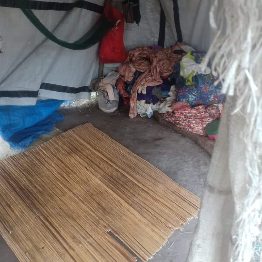 Monica and Children's sleeping mart inside the tarp shelter 