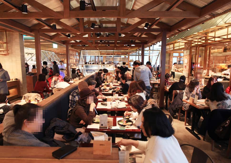 Customers enjoying lunch at a large Korean buffet restaurant before covid 19 outbreak