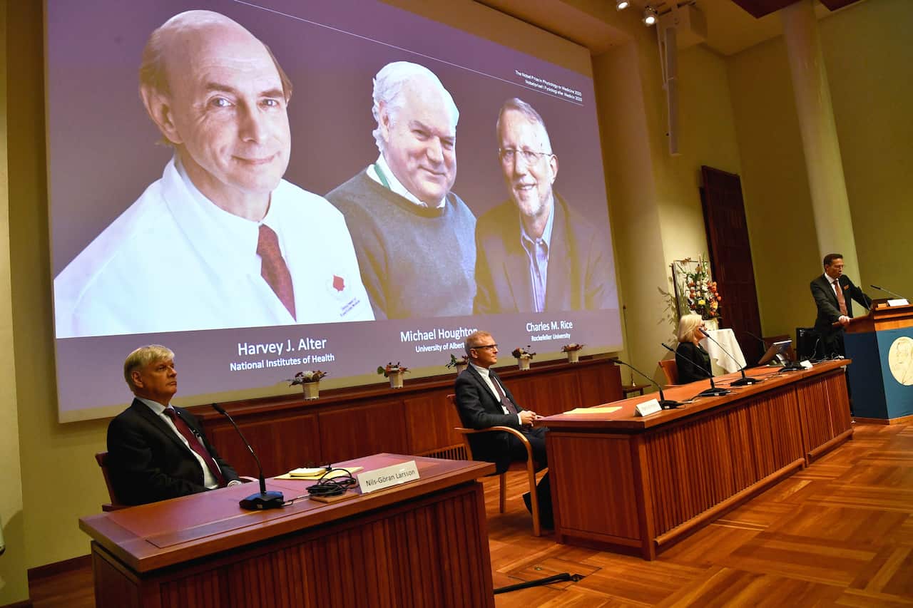 Thomas Perlmann, far right, Secretary of the Nobel Assembly announces the 2020 Nobel laureates in Physiology or Medicine during a news conference in Sweden.