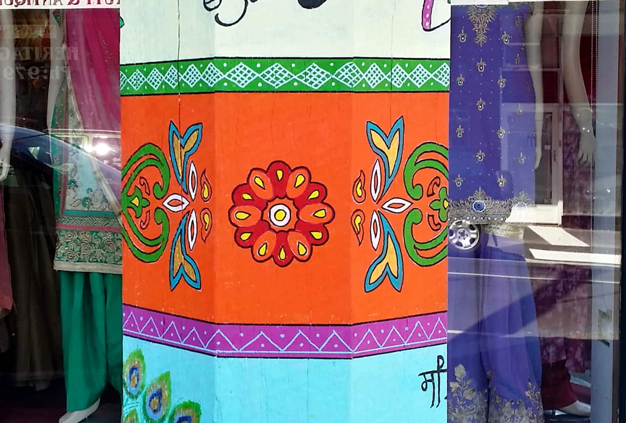 Sohail Yamin painting pole at Little India cultural precinct