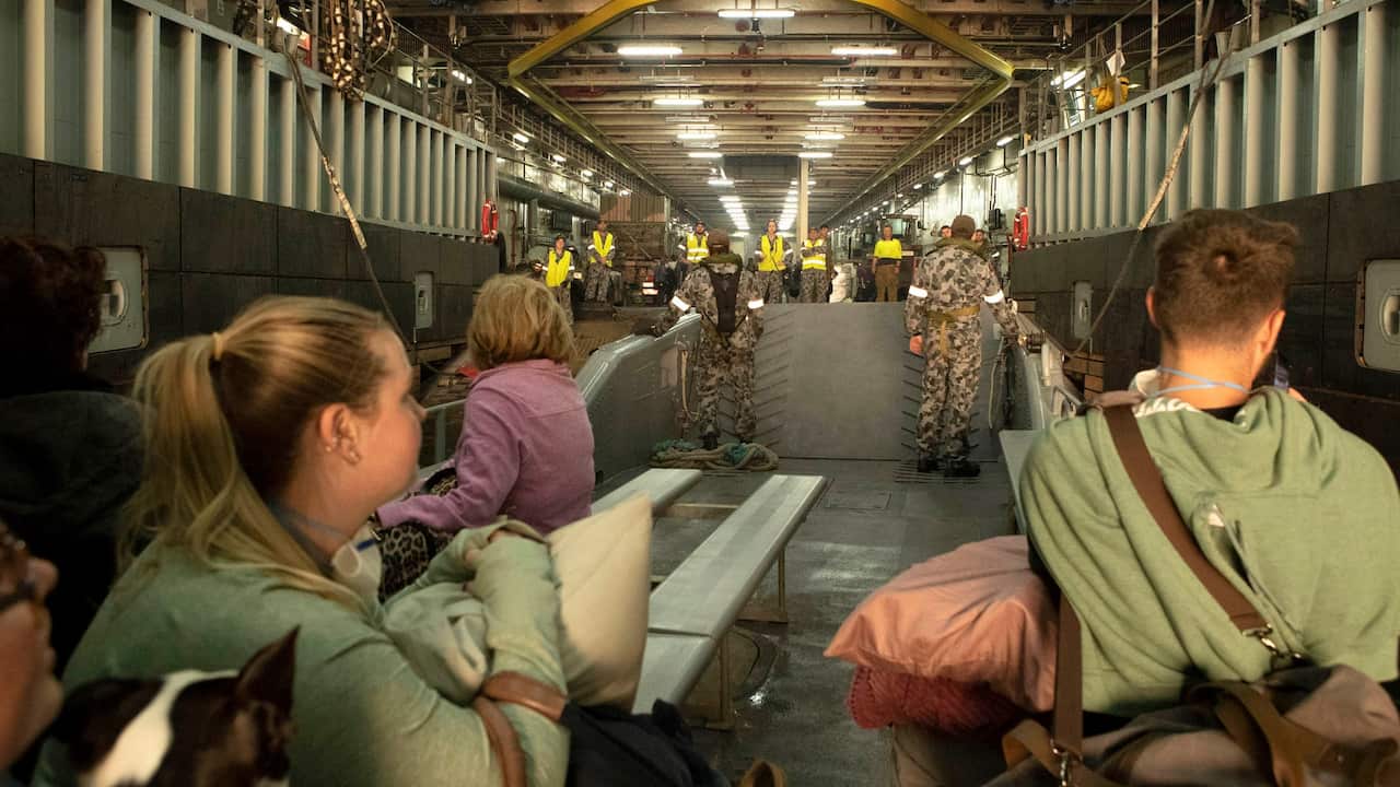 Evacuees from Mallacoota board HMAS Choules.  