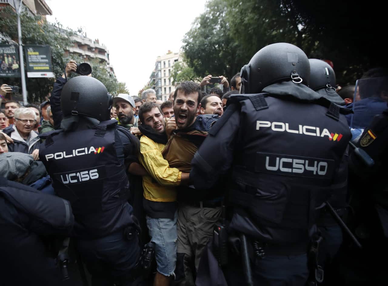 Catalan people who gathered outside the Ramon Llull school clash with Spanish National riot policemen during the '1-O Referendum' in Barcelona, Catalonia, on 01 October 2017. 