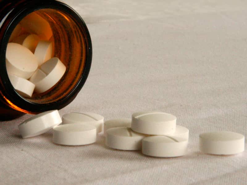 Pills fall from a bottle