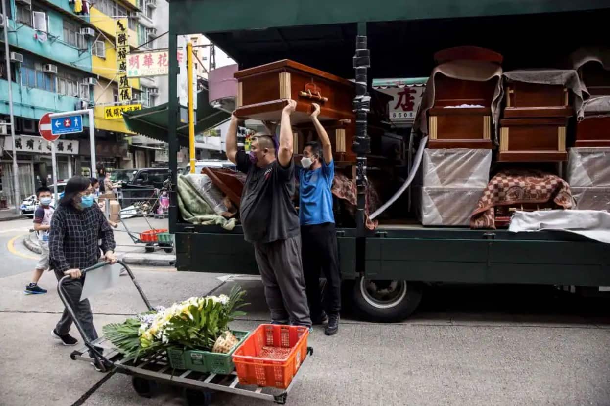 Empty coffins are delivered to a funeral services shop and funeral parlours in the Kowloon district of Hong Kong. A funeral industry representative on 16 March told local media the soaring death toll due to COVID-19 had seen a crunch in the city's coffins