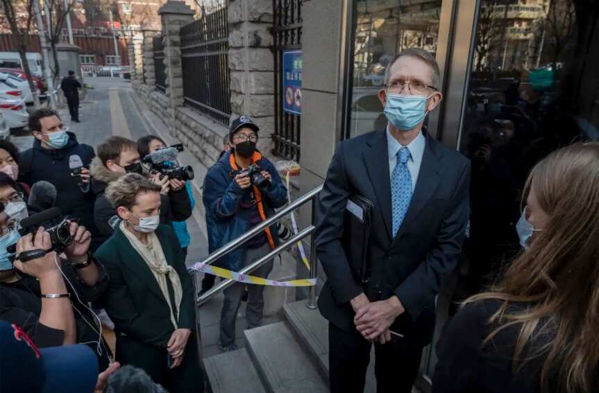 Australian ambassador to China Graham Fletcher waits at the doorway before being turned away by court officials and police as he tried to enter the trial of Chinese Australian journalist Cheng Lei.