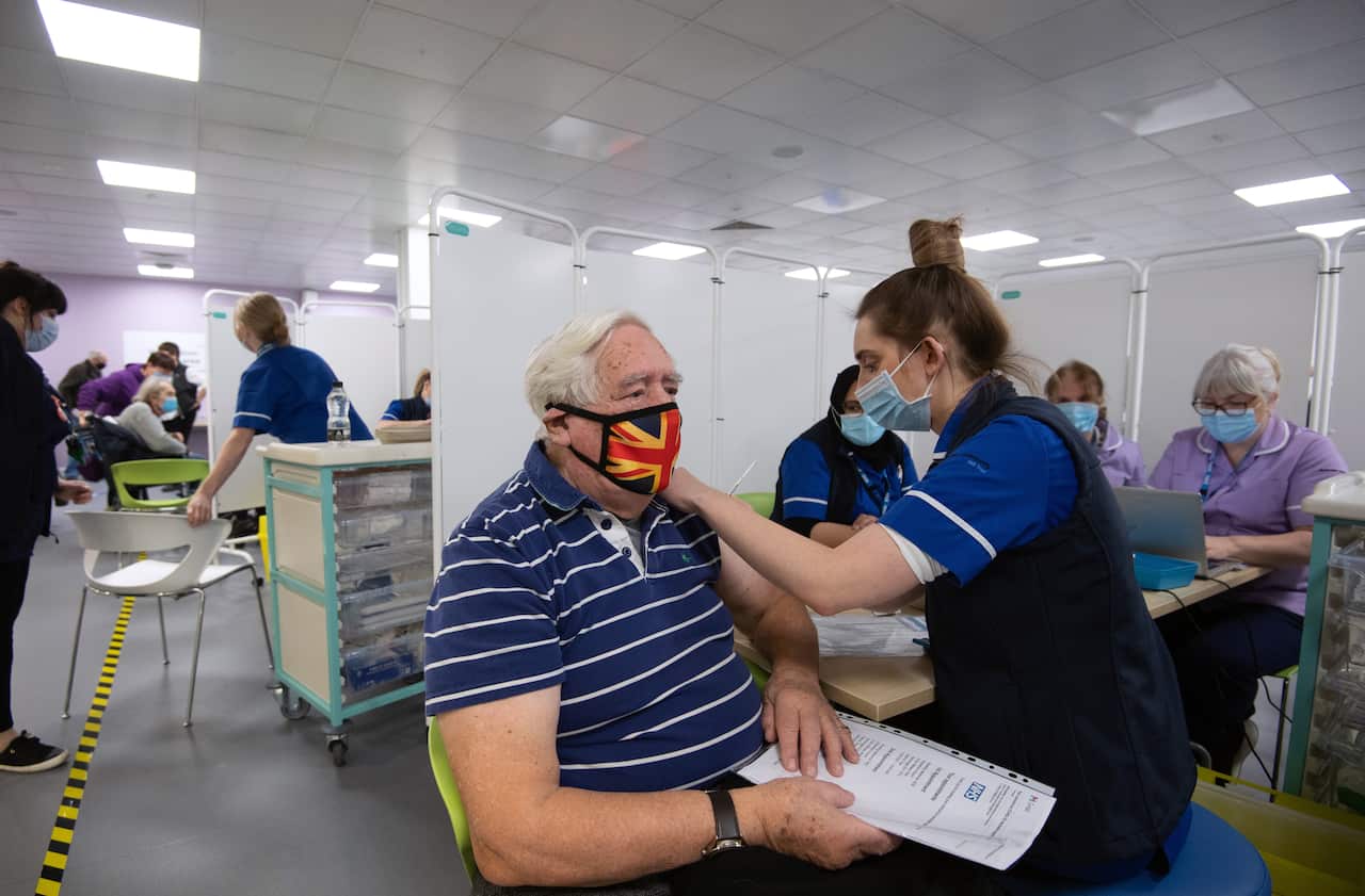 Robert Williams, 84, receives an injection of a Covid-19 vaccine at a British vaccine centre.