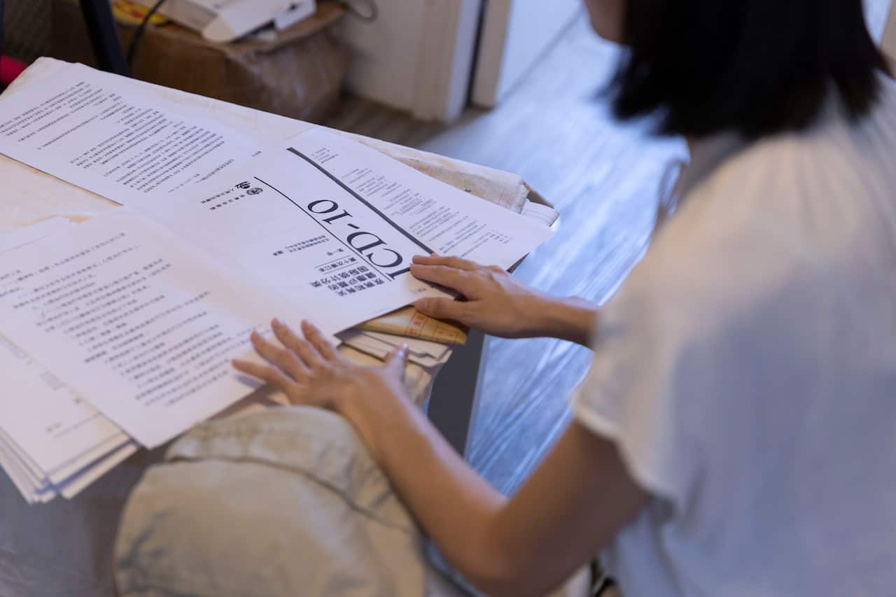 Xixi looks through her research and evidence.