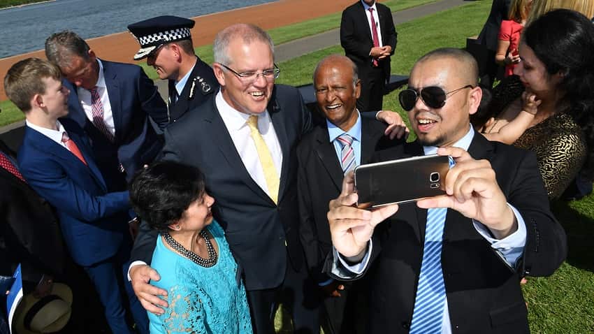 Prime Minister Scott Morrison takes a selfie with newly-sworn citizens at an Australia Day Citizenship Ceremony
