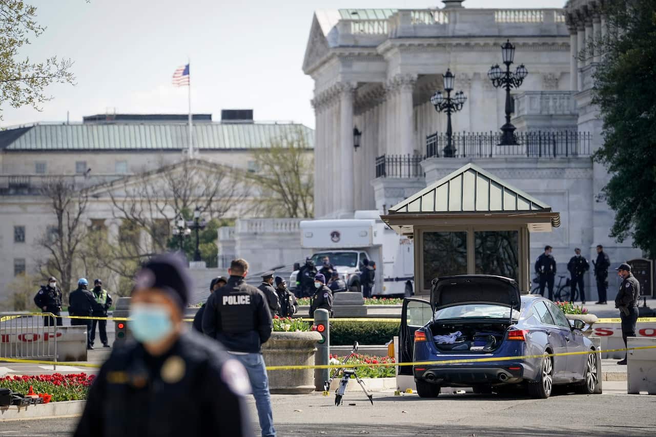 Police investigate the scene after a vehicle charged a barricade at the US Capitol on 2 April in Washington, DC. 