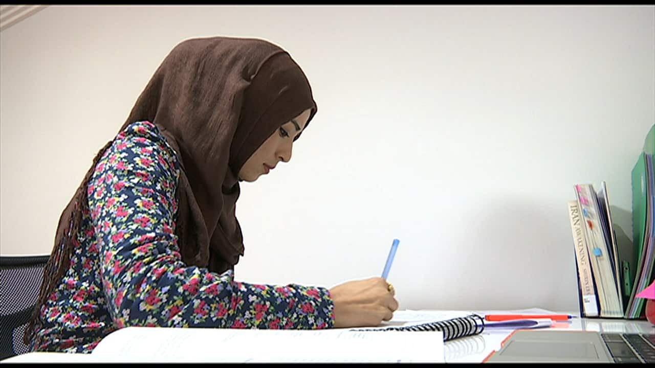 Shukufa Tahiri studying for her university law exams. (SBS)