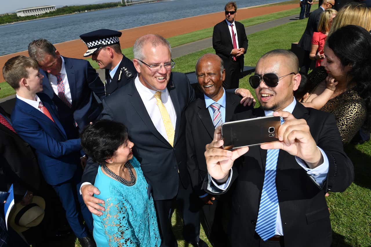 Prime Minister Scott Morrison takes a selfie with newly sworn citizens at an Australia Day Citizenship Ceremony and Flag Raising event in Canberra, Saturday, January 26, 2019. (AAP Image/Mick Tsikas) NO ARCHIVING
