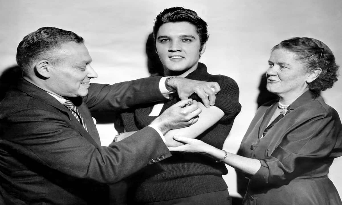 Elvis Presley receives a polio vaccination from doctors at the CBS studios, New York, in 1956.