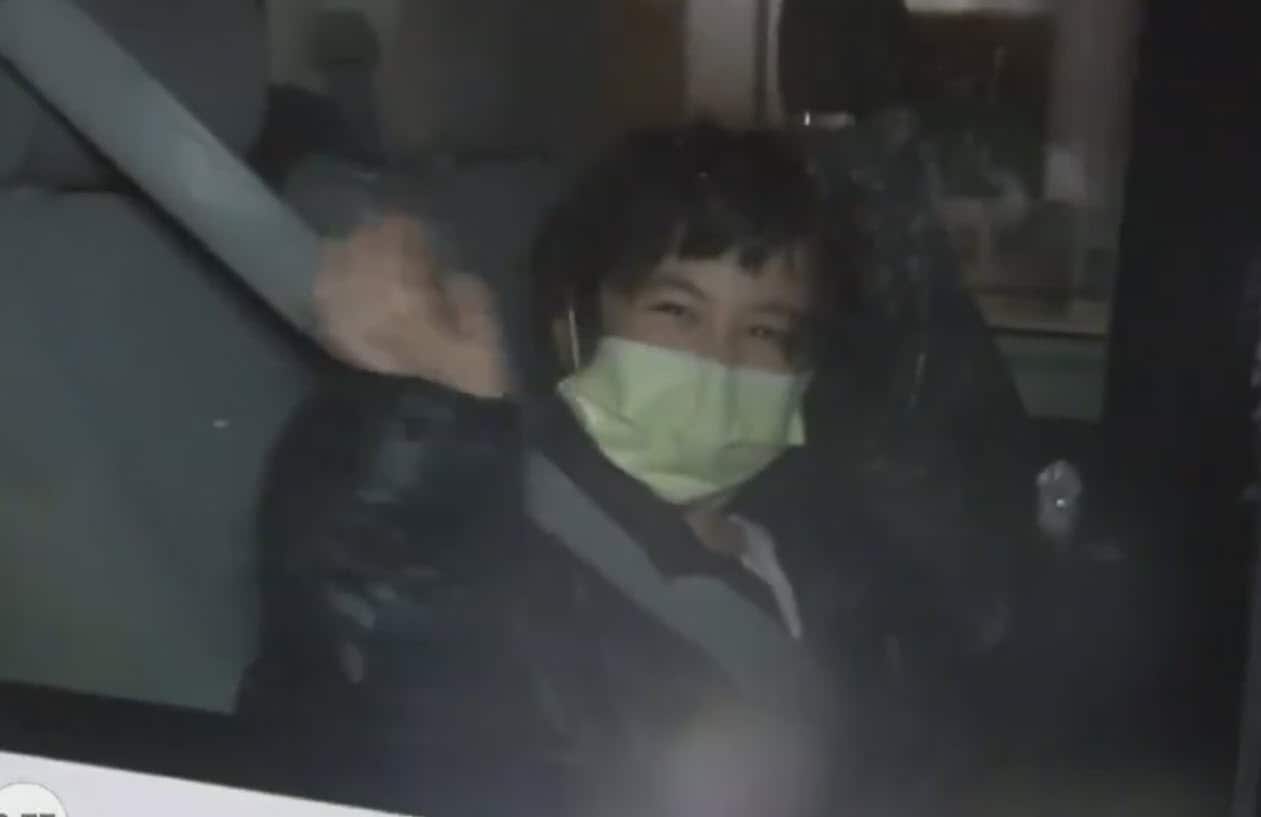 A woman seen smiling and waving after having been evacuated to Christmas Island from the coronavirus epicentre of Wuhan in China.