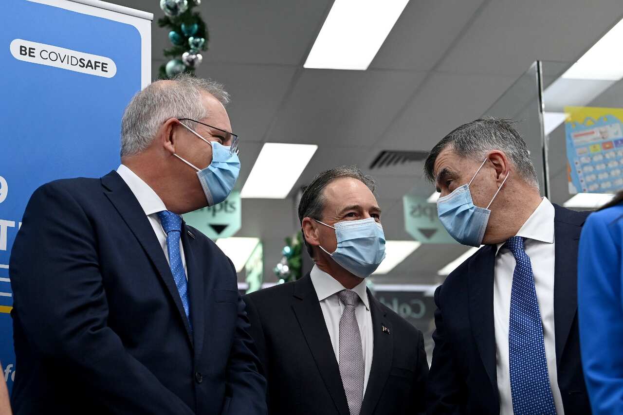Prime Minister Scott Morrison, Health Minister Greg Hunt and Secretary of the Department of Health Brendan Murphy on 10 December 2021. 