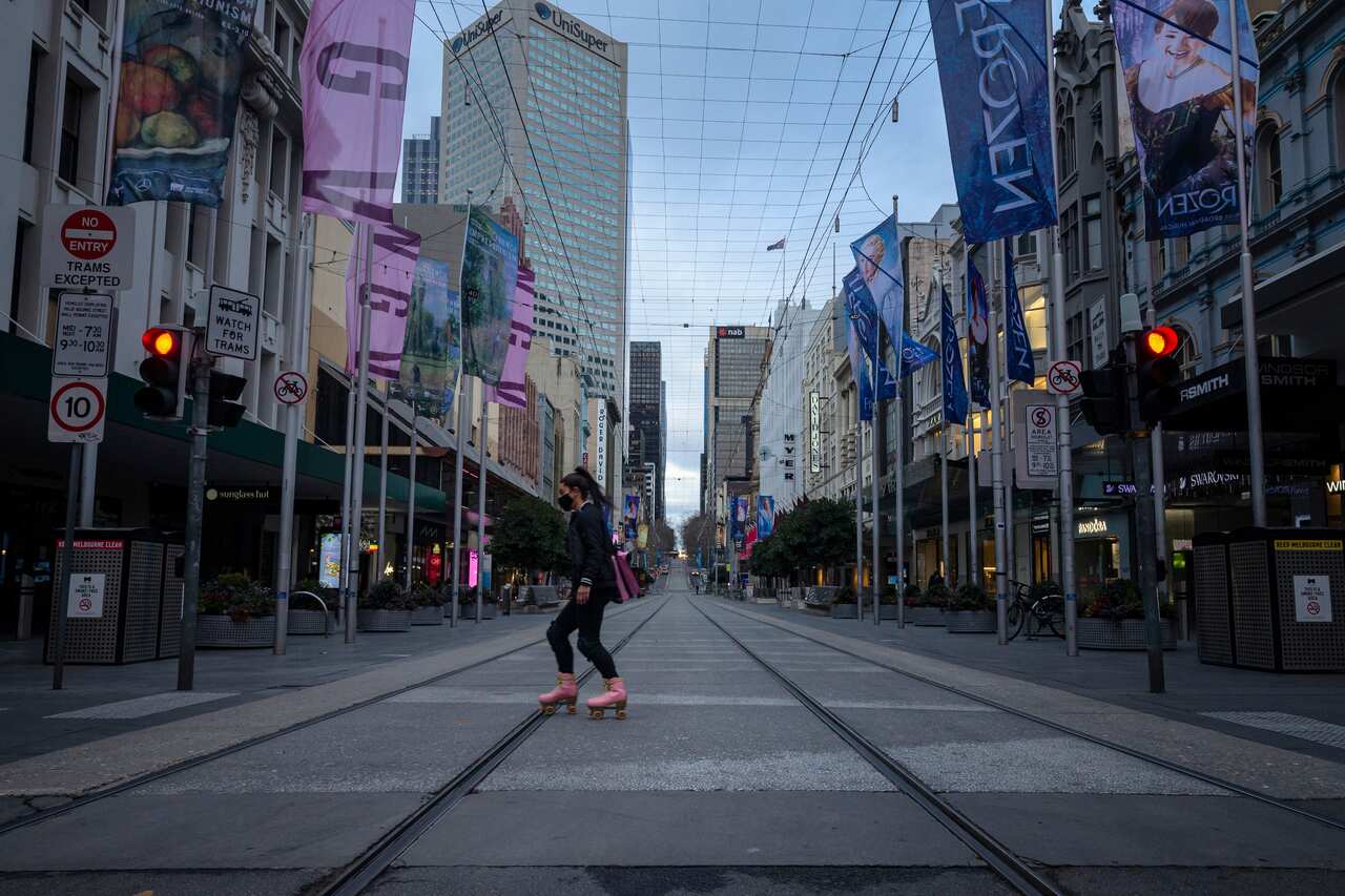 A person roller skates across a quiet Bourke Street Mall in Melbourne on Friday morning.