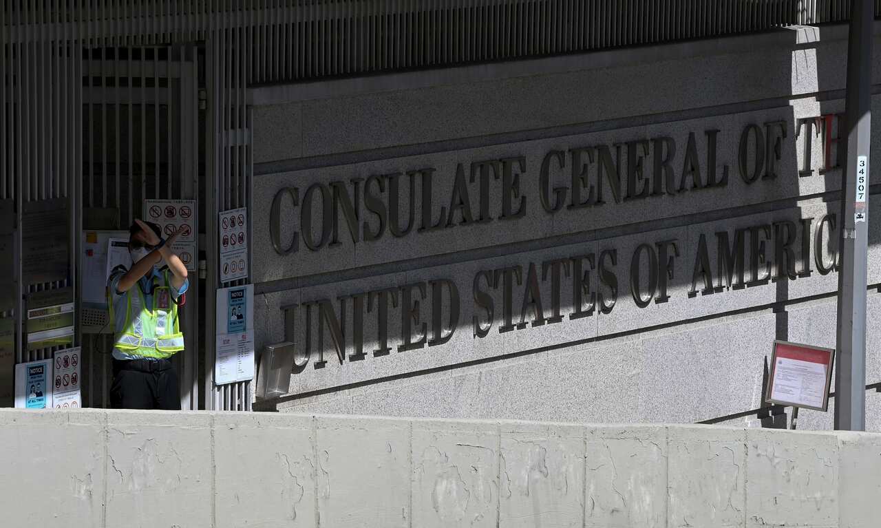 A security guard gestures outside the US consulate in Hong Kong on 27 October.