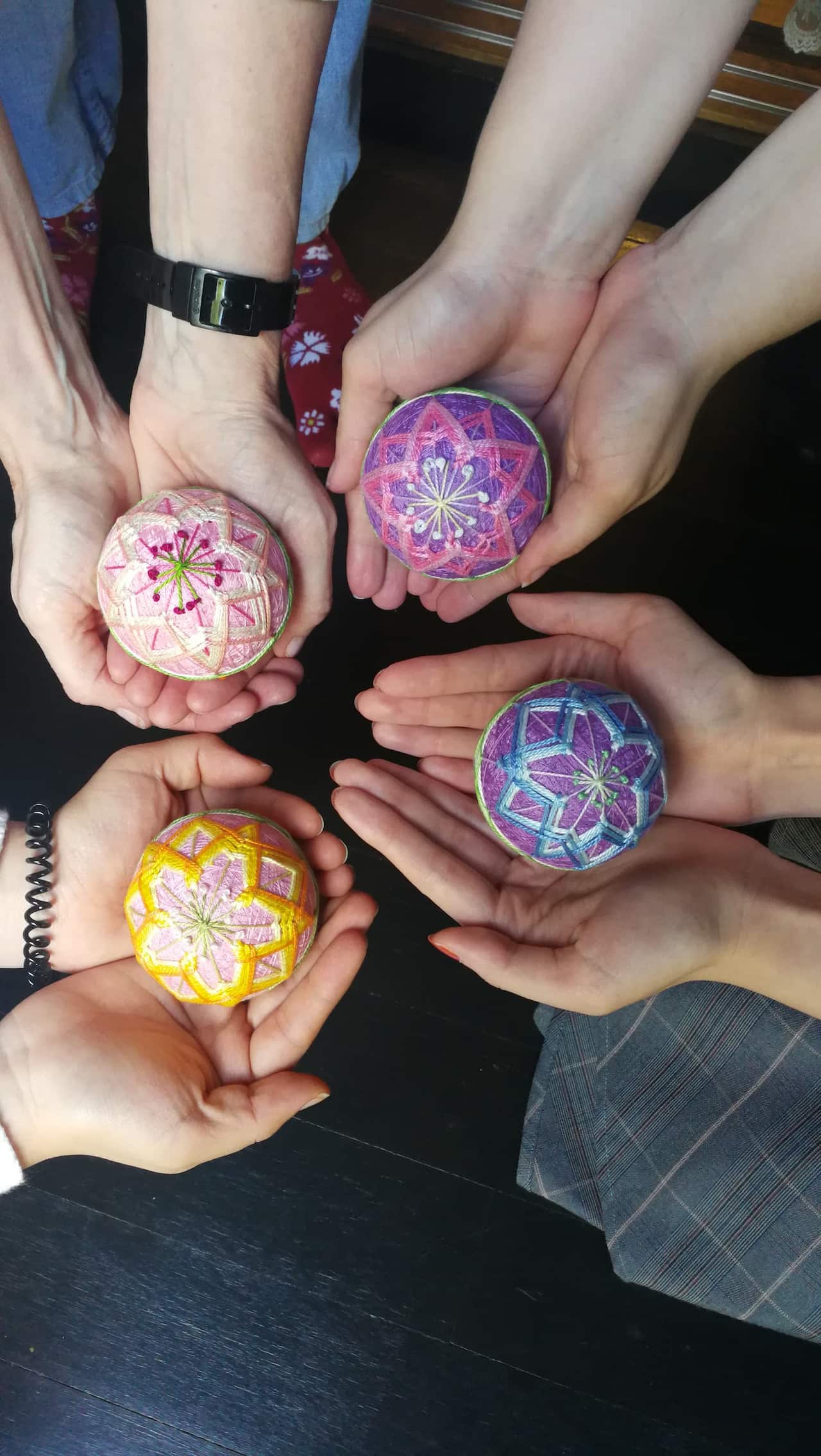 Participants for Chihiro Kownacki's Japanese temari ball making workshop showing their temari balls.
