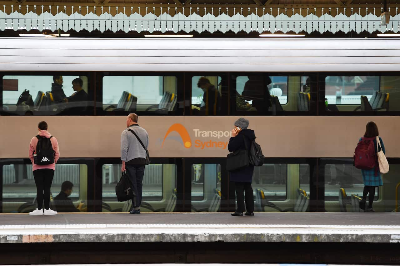 Commuters and school students return to public transport at Strathfield Train Station in Sydney on Monday.