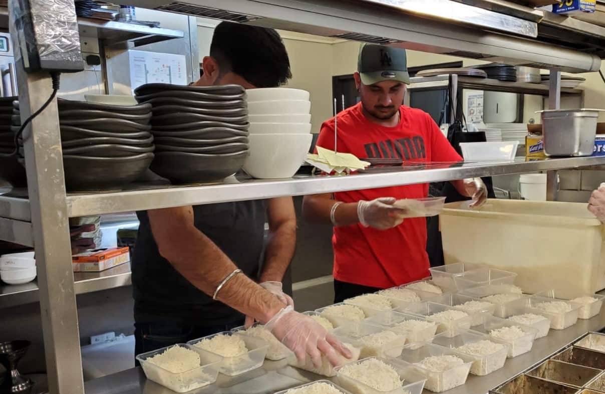 Representational image of volunteers preparing food for needy people.