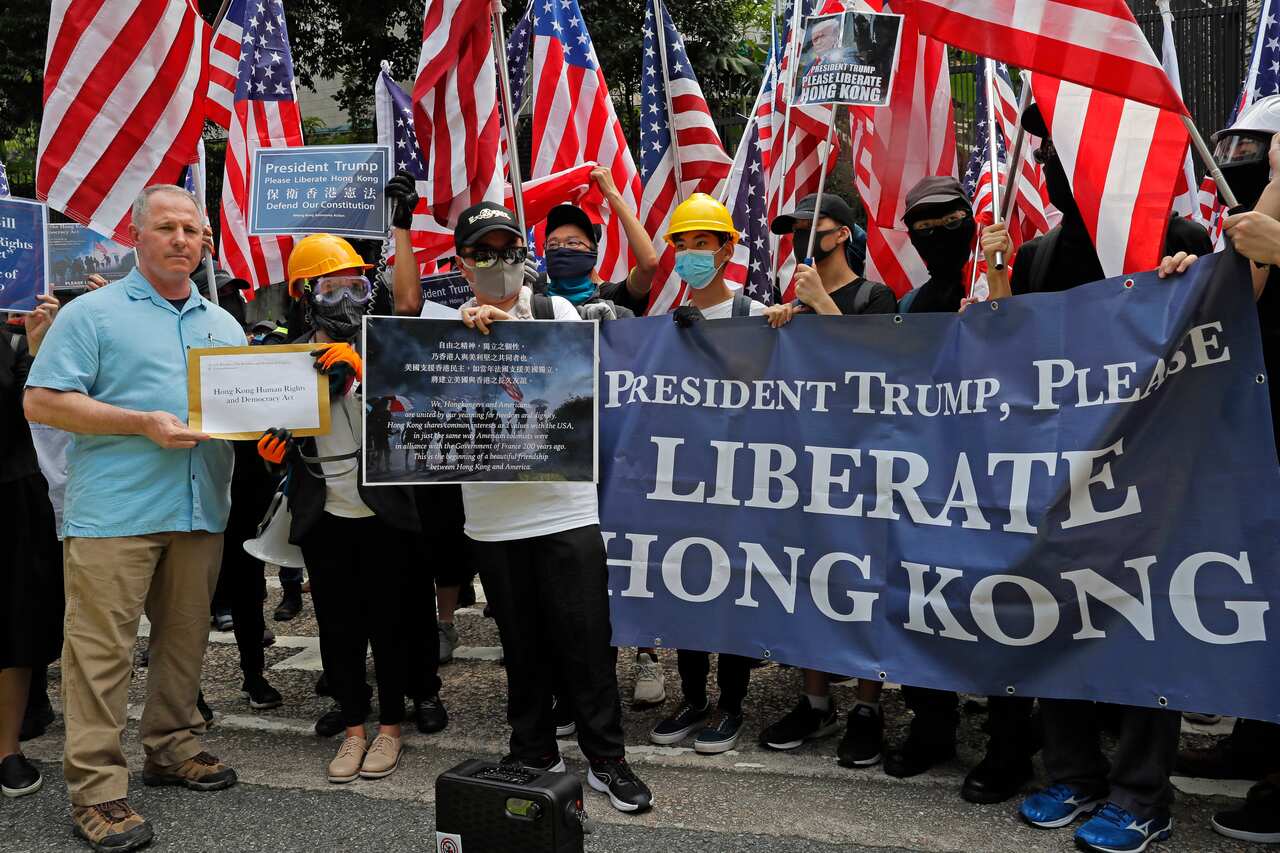 Thousands of Hong Kong demonstrators marched to the U.S. Consulate on Sunday, urging President Donald Trump to help "liberate" their city.