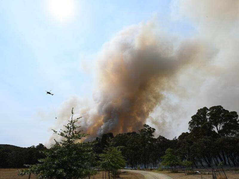 water bombing helicopter over bushfire smoke in Victoria