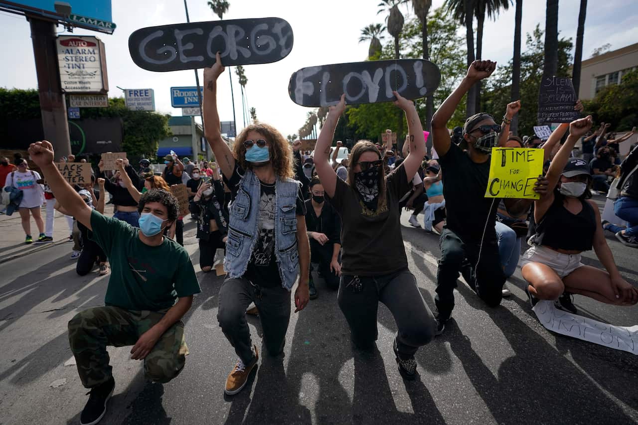 Demonstrators kneel in Los Angeles during a protest over the death of George Floyd.