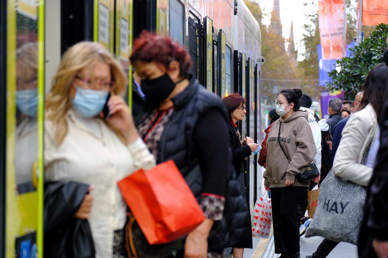 Commuters are seen  wearing a face mask while using the  public transport in Melbourne.