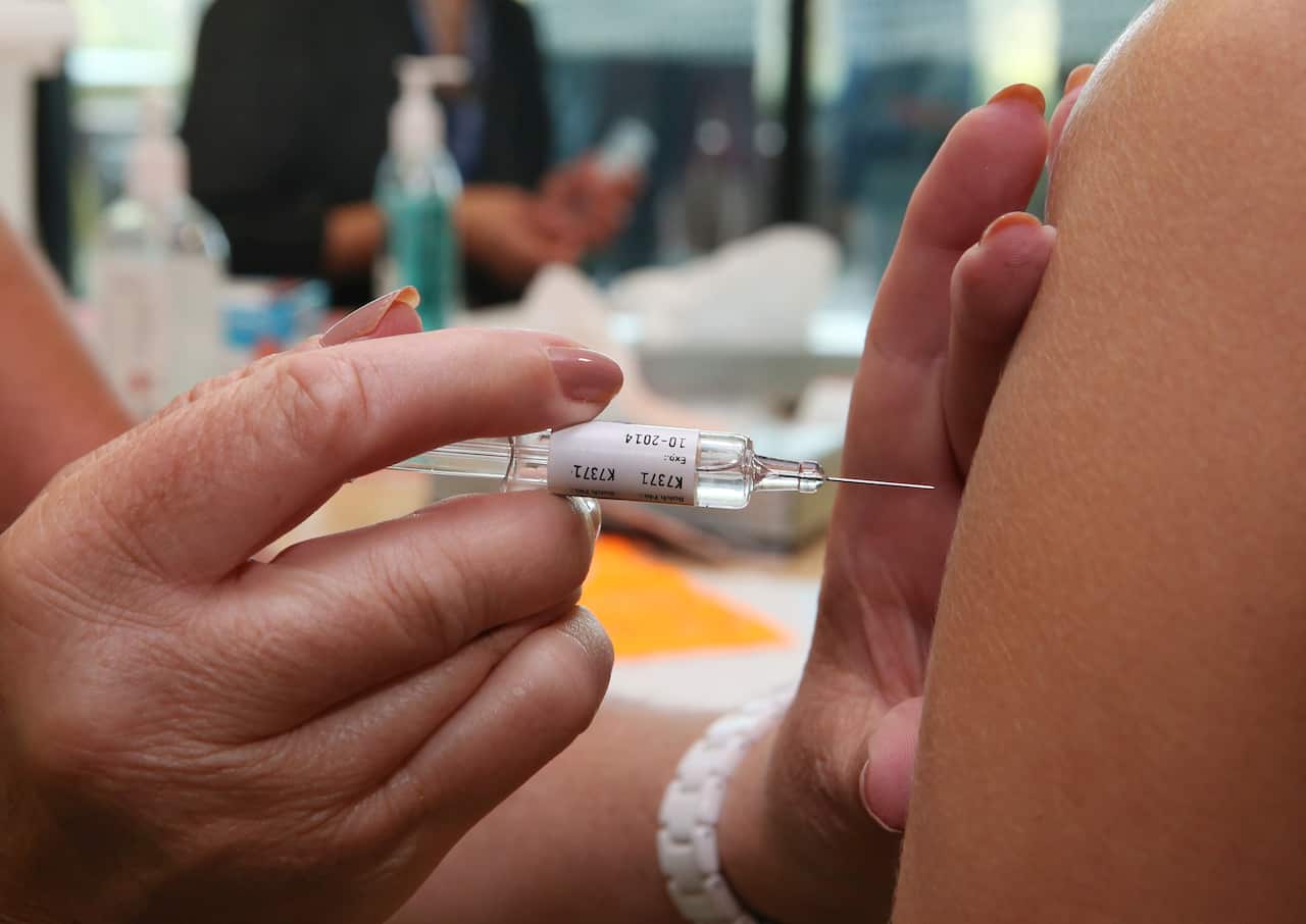 Health care workers receive the flu vaccination injection at the Royal Children's Hospital in Melbourne, Tuesday, March 4, 2014. 