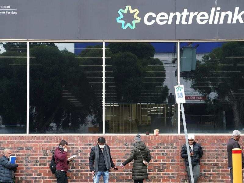 People are seen queuing outside a yet to open Centrelink office.