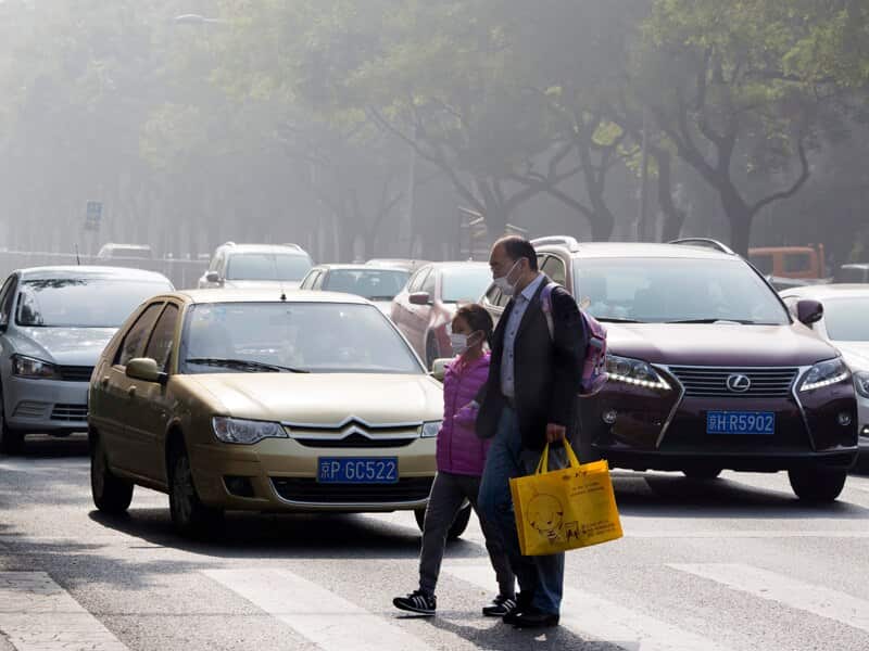 A man and a child wear masks during a polluted day in Beijing, China