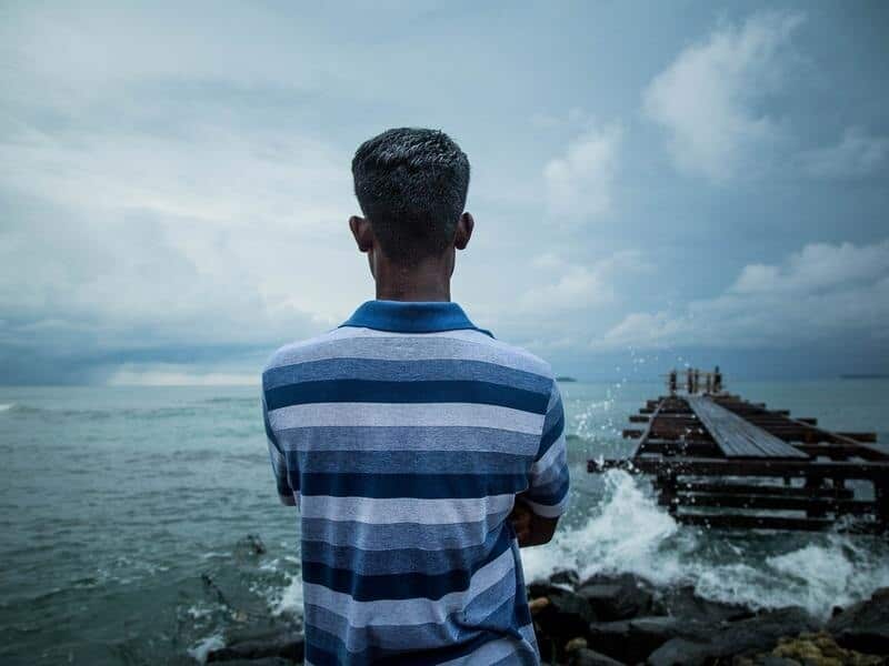 A supplied image of a refugee looking out to the sea on Manus Island.