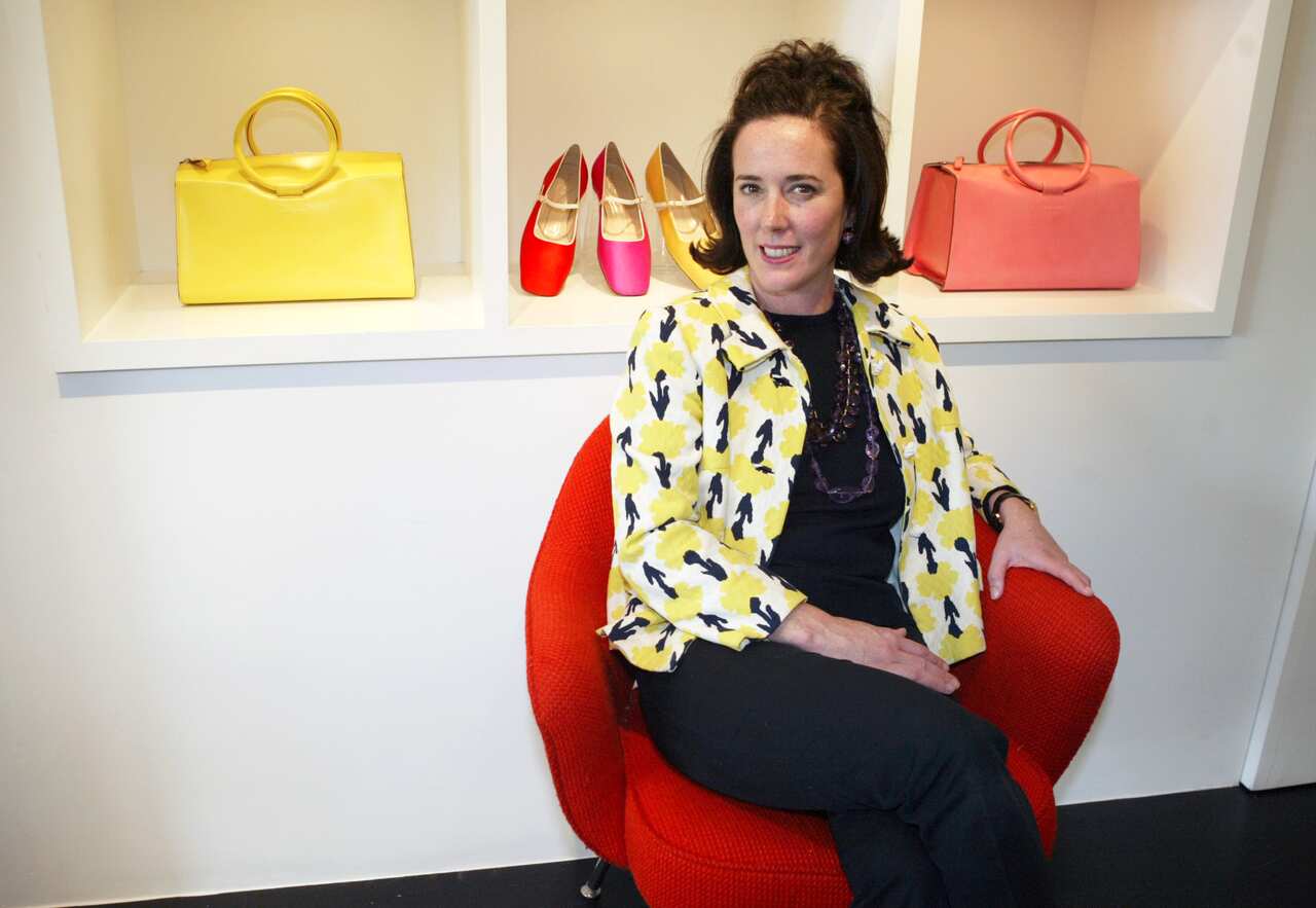 This May 13, 2004 photo shows designer Kate Spade posing among handbags and shoes from her collection in New York. (AP Photo/Bebeto Matthews, File)