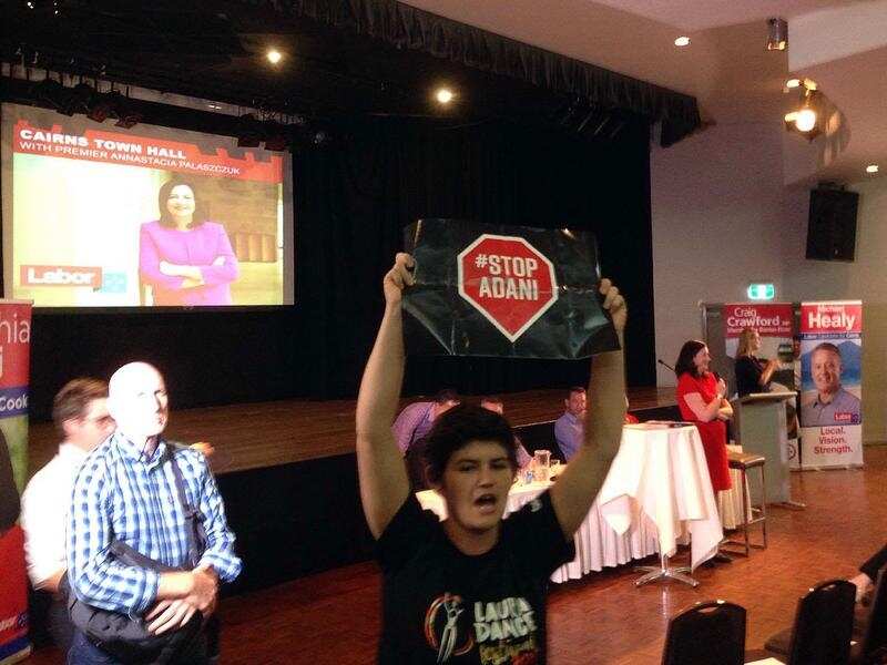 A protester disrupts a meeting held by the Queensland premier