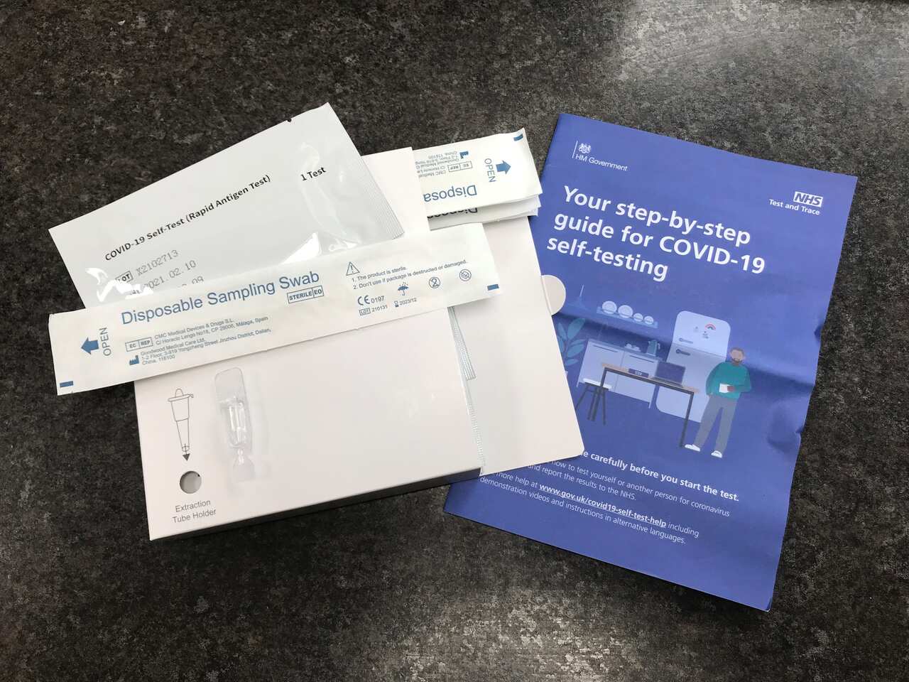 A package of seven NHS Test and Trace COVID-19 rapid antigen self-testing kits which were received in the mail after being ordered online in the UK.  