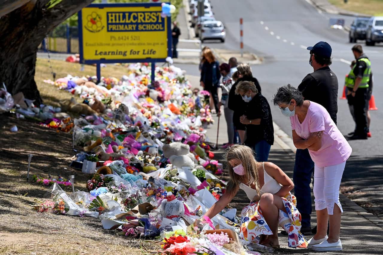 Members of the public pay their respects outside Hillcrest Primary School in Devonport, Tasmania on 22 December 2021.