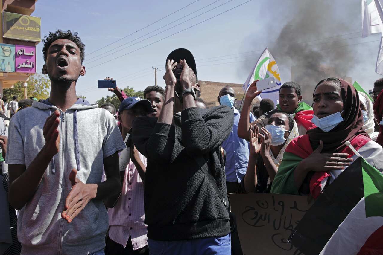 People chant slogans during a protest to denounce the October military coup in Khartoum, Sudan.